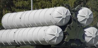 Close-up of a military missile system with cylindrical launchers