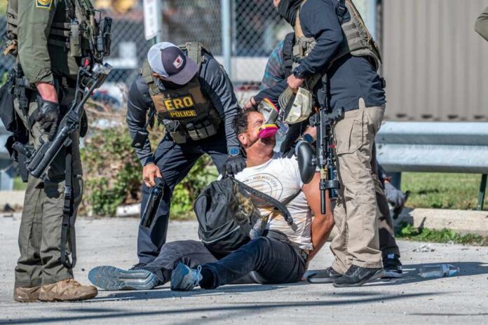 Police officers apprehending a suspect on the ground