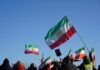 Crowd holding Iranian flags during a protest against the government