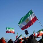 Iran’s AK-47 Training Shocks Viewers Crowd holding Iranian flags during a protest against the government