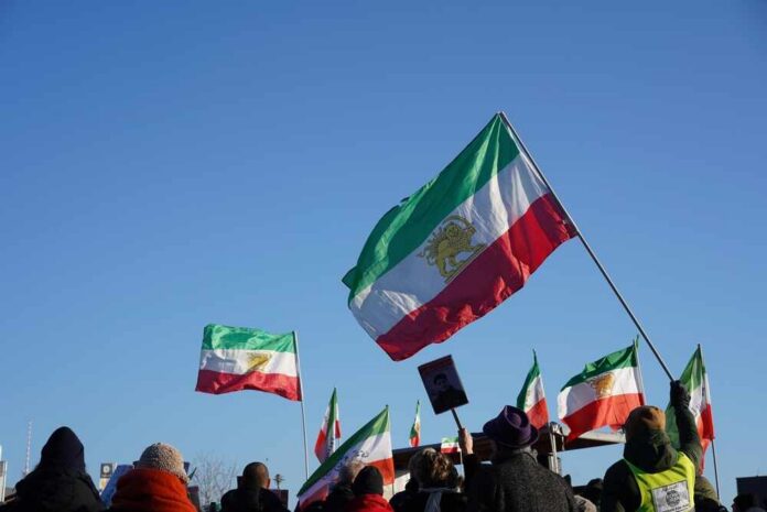 Berlin,,Germany,-,January,18,,2026:,Dramatic,Lion-sun,Flags,Waving Crowd holding Iranian flags during a protest against the government