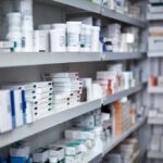 Detroit Drug Fraud Scandal: $5.6M Taxpayer Heist Shelves filled with various medication boxes and containers in a pharmacy