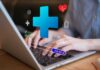 Person typing on a laptop with health-related icons displayed
