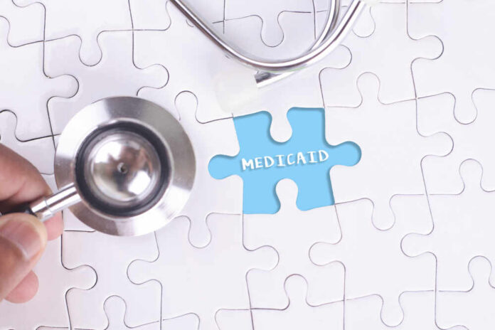 A stethoscope next to a puzzle piece labeled 'Medicaid'