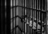 Close-up of prison bars casting shadows on a wall