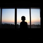 Outrage Whiplash: Nepo Babies Eclipse #MeToo Silhouette of a child looking out a window at a sunset