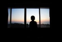 Outrage Whiplash: Nepo Babies Eclipse #MeToo Silhouette of a child looking out a window at a sunset