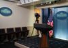 Empty White House press room with a podium and camera setup