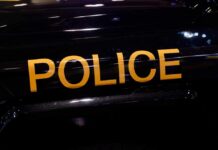 Close-up of a police vehicle with the word 'POLICE' prominently displayed