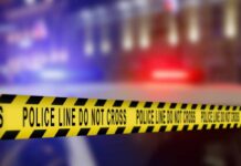 Fly‑Tipped Trap Leaves Cyclist Skull‑Shattered Yellow police tape reading 'DO NOT CROSS' at a crime scene
