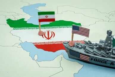 Map of Iran with Iranian and U.S. flags and a model warship