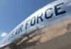 Close-up of a U.S. Air Force aircraft with a shiny metallic surface against a blue sky