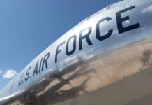 Close-up of a U.S. Air Force aircraft with a shiny metallic surface against a blue sky
