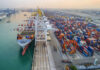 Aerial view of a busy shipping port with cargo containers and a large ship