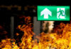 Bangkok Nightclub Horror, But Why Trapped? Green emergency exit sign with flames in the foreground