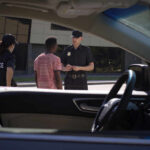 Police officers interacting with a civilian during a traffic stop