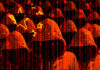AI-Powered Heists Go Next-Level Abstract representation of hackers with binary code in a red and black color scheme
