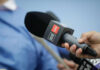 Media Smackdown: Operative Theory Meets Reality A hand holding a CNN microphone during a news interview