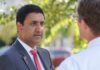 Congressman Held At Gunpoint—By U.S.-Armed Settlers Two professionals engaged in a conversation outdoors