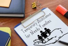 Clipboard with TANF form and family icon on desk