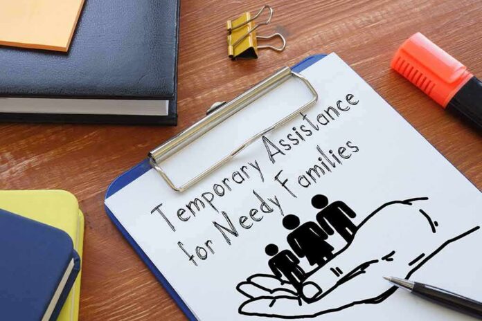 Clipboard with TANF form and family icon on desk