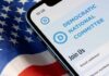 Imposter Email Bleeds DNC Funds Smartphone showing a political committee webpage on an American flag
