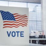 Voting booth with American flag design in a modern polling place