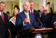Shock Death Stuns Capitol A group of government officials at a press conference with one speaking into a microphone