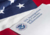 Court Slams Congress: Hands OFF Citizenship U.S. flag with a document from U.S. Immigration and Customs Enforcement