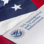 U.S. flag with a document from U.S. Immigration and Customs Enforcement