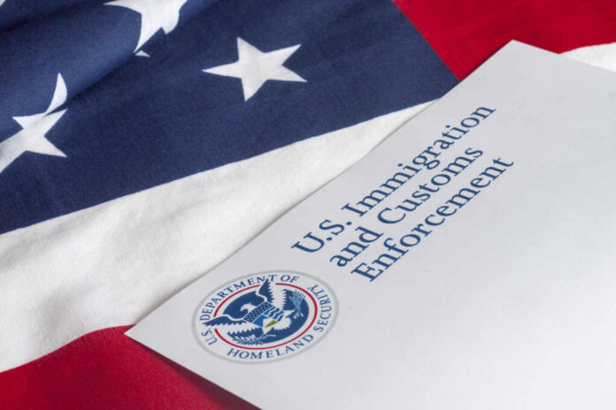 Us,Customs,And,Border,Enforcement,And,Usa,Flag U.S. flag with a document from U.S. Immigration and Customs Enforcement