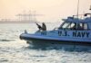 U.S. Navy patrol boat with armed crew on the water