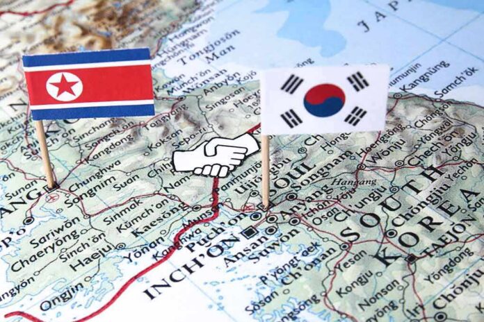 shutterstock_1078499288-2 Map of Korean Peninsula with North and South Korean flags and handshake icon
