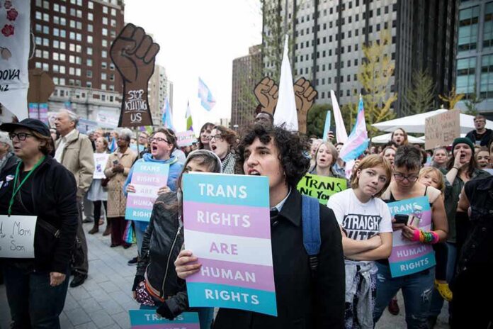 Protesters holding signs at a transgender rights rally