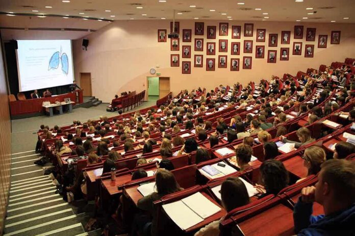 Students seated in a lecture hall listening to a presentation