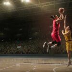 Two basketball players contest a layup under the hoop