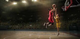 Two basketball players contest a layup under the hoop