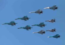 A formation of military jet fighters flying in a clear blue sky