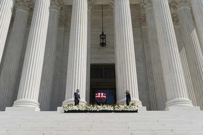 Flag-draped casket on courthouse steps between towering columns
