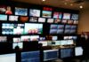 control room with multiple screens and monitors