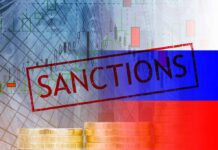 Sanctions text over financial chart and flag with coin stacks