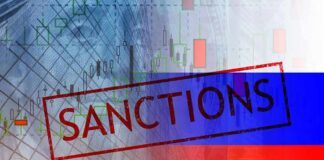 Sanctions text over financial chart and flag with coin stacks