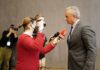 man in suit being interviewed by reporters