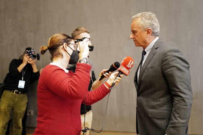 man in suit being interviewed by reporters