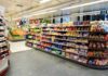 Supermarket aisle with shelves of snacks and candy