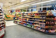 Supermarket aisle with shelves of snacks and candy