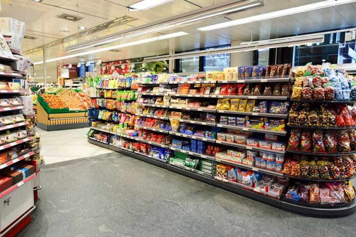 Supermarket aisle with shelves of snacks and candy