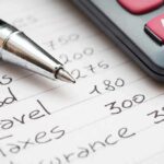 Budget list with pen and calculator