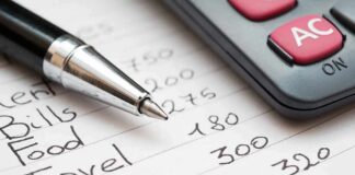 Budget list with pen and calculator