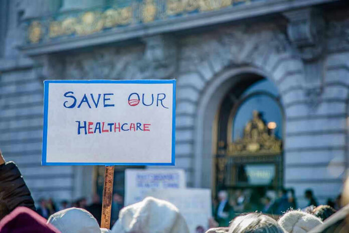 Sign reading Save Our Healthcare at protest.